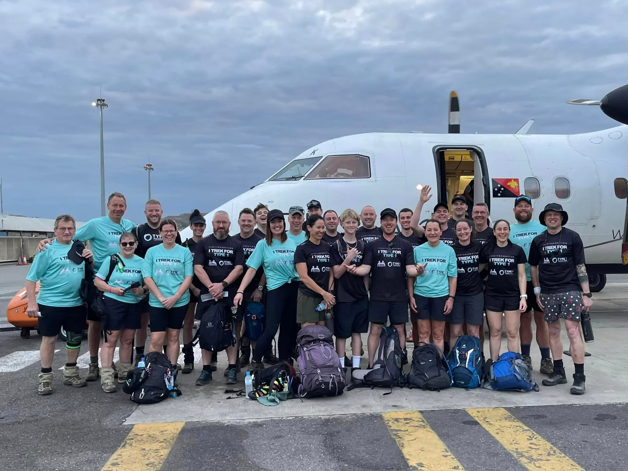 Type 1 Foundation charity trekkers in front of their charter flight to Kokoda