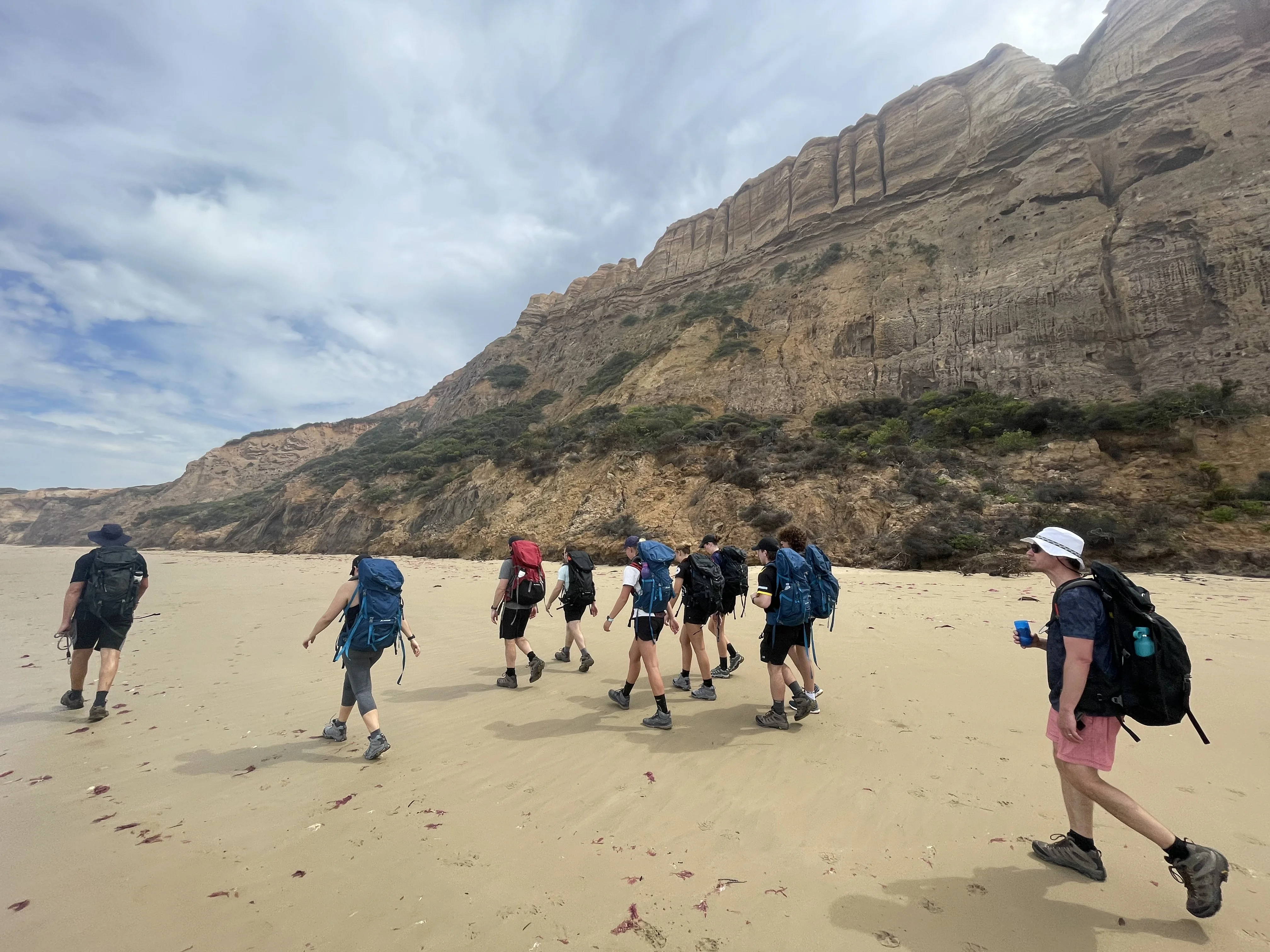 Trekkers training on a beach hike for the Kokoda Track