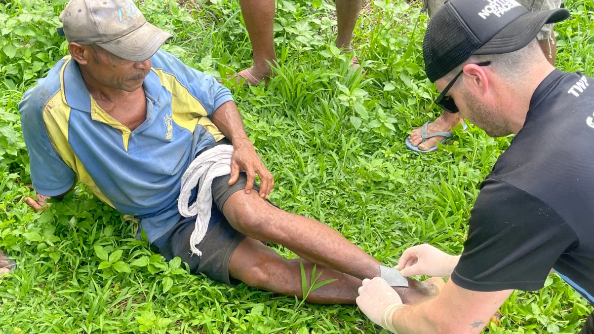 Kokoda Courage critical care medic treating a local villager on the Kokoda Track