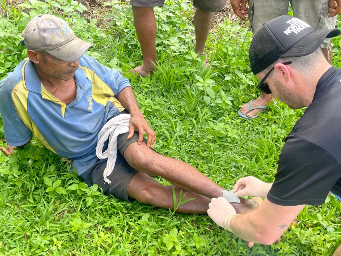 Kokoda Courage critical care medic treating a local villager on the Kokoda Track